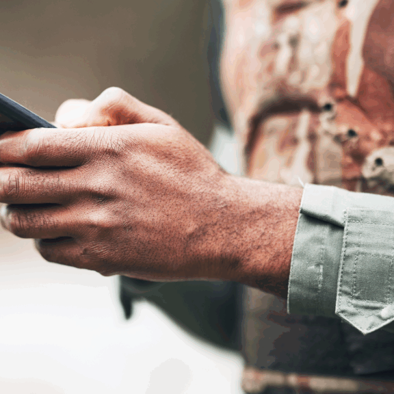 Image of a man on a phone for an article detailing: There is a war going on all around us. This war takes place on the “digital battlefield", composed of the screens that we see every day.