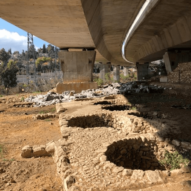 Remains of Tel Motza. It was discovered by construction workers as they built a bridge across a valley. As you can see, parts of the site were destroyed in the construction process. The site is of interest because excavators found a small, fully functional replica of the Jerusalem Temple built here. Photo by John Buckner