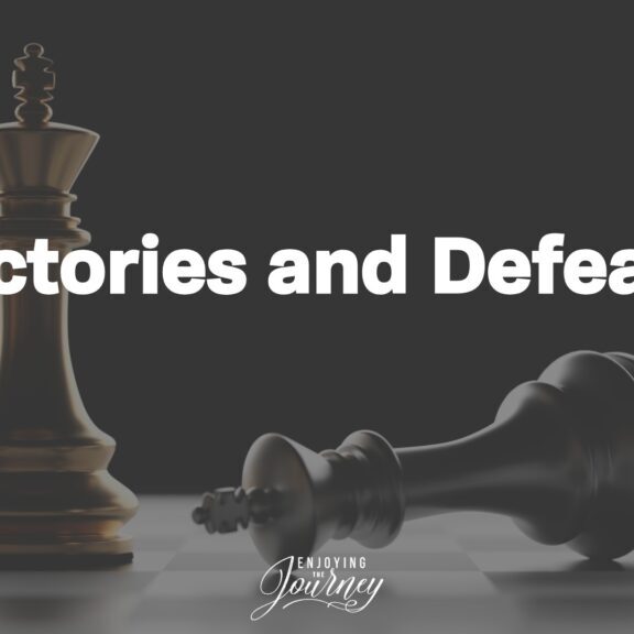 Two king chess pieces, one standing and one falling