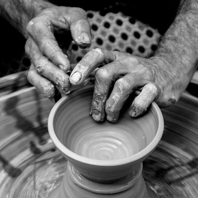 Potter's hands making a vessel to be used.