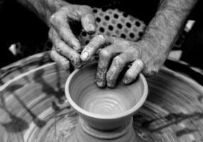 Potter's hands making a vessel to be used.